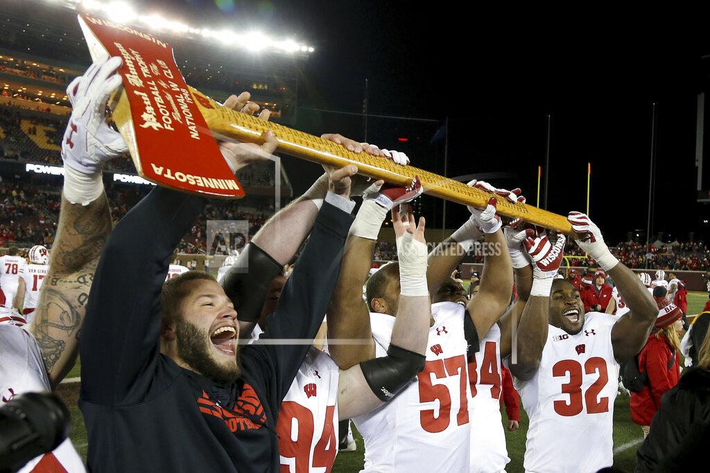 Stacy Bengs FILE - In this Nov. 25, 2017, file photo, Wisconsin players hold up Paul Bunyan's Axe up after winning 31-0 against Minnesota in an NCAA college football game, in Minneapolis. More than Paul Bunyan’s Axe is on the line in college football’s most-played rivalry. The winner of Saturday’s game between No. 9 Minnesota and No. 13 Wisconsin wins a division title, and plays No. 2 Ohio State in the Big Ten title game. (AP Photo/Stacy Bengs, File)