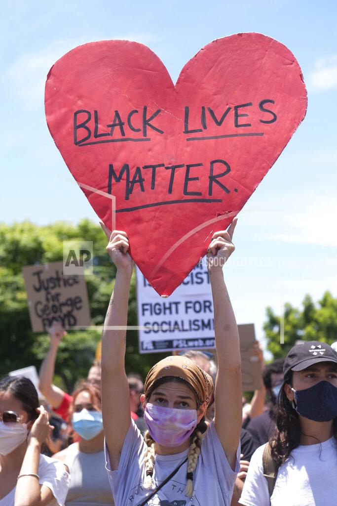 Ringo H.w. Chiu A protester holds a sign during a protest in Los Angeles, Saturday, May 30, 2020. Demonstrators took to the streets of Los Angeles to protest the death of George Floyd, a black man who was killed in police custody in Minneapolis on May 25. (AP Photo/Ringo H.W. Chiu)