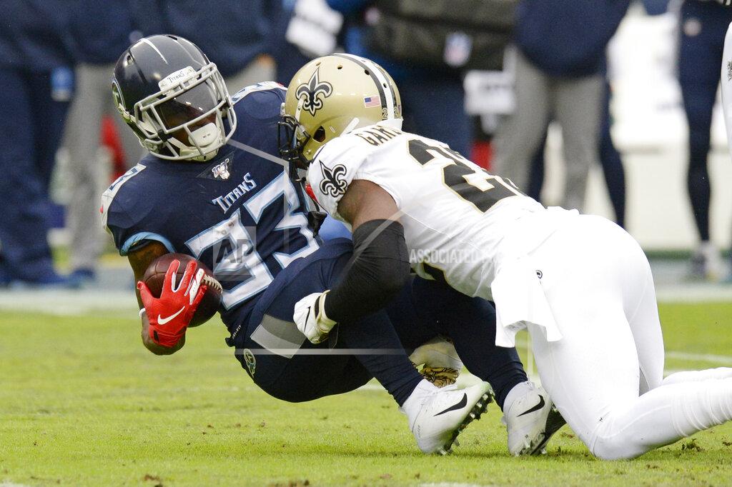 Mark Zaleski Tennessee Titans running back Dion Lewis (33) is stopped by New Orleans Saints defensive back Chauncey Gardner-Johnson (22) in the first half of an NFL football game Sunday, Dec. 22, 2019, in Nashville, Tenn. (AP Photo/Mark Zaleski)