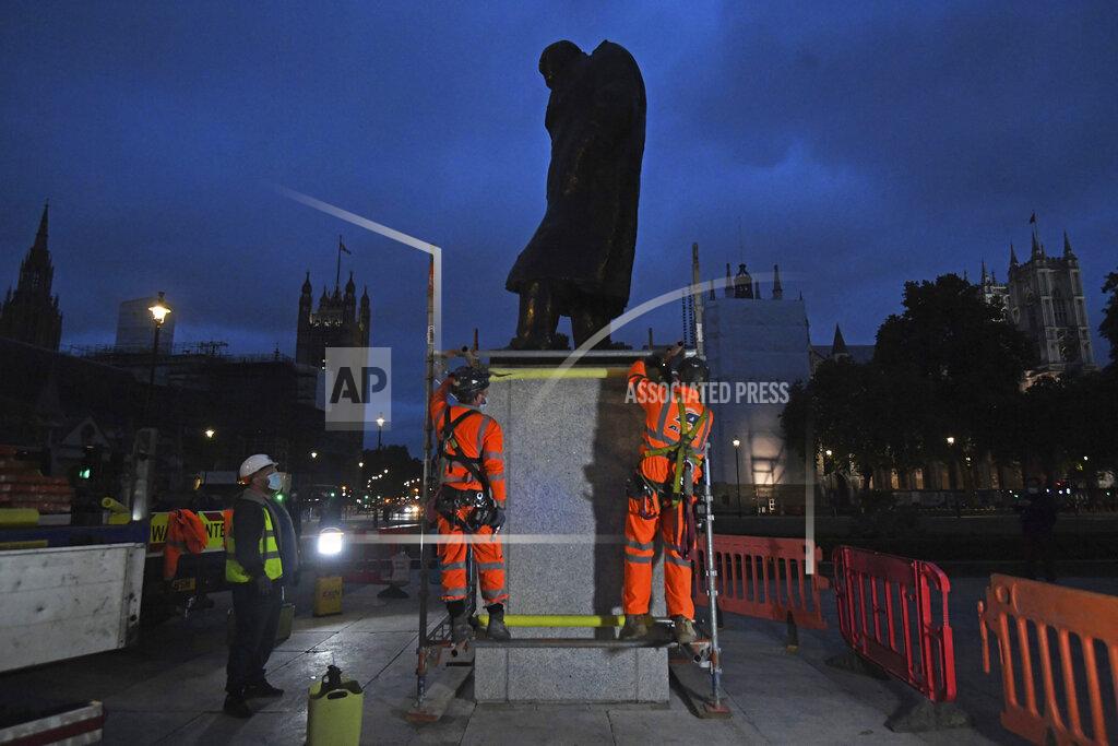Kirsty O'connor Scaffolders erect boarding around the statue of Sir Winston Churchill at Parliament Square, in London, Thursday, June 11, 2020, following Black Lives Matter protests that took place across the U.K. over the weekend. The protests were ignited by the death of George Floyd, who died after he was restrained by Minneapolis police while in custody on May 25. (Kirsty O'Connor/PA via AP)