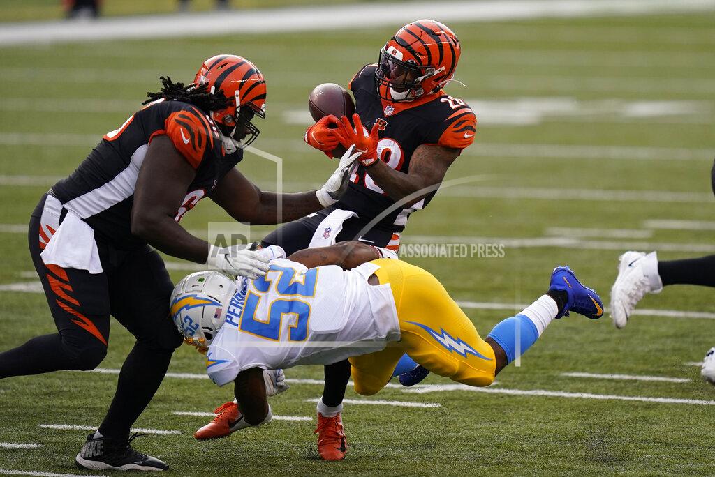Bryan Woolston Cincinnati Bengals running back Joe Mixon (28) fumbles as he is hit by Los Angeles Chargers' Denzel Perryman (52) during the second half of an NFL football game, Sunday, Sept. 13, 2020, in Cincinnati. (AP Photo/Bryan Woolston)