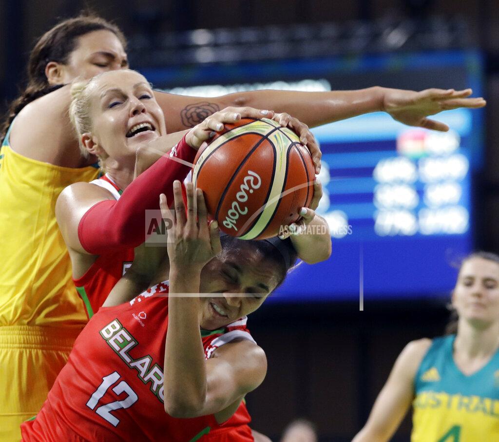 FILE - In this Aug. 13, 2016, file photo, Belarus guard Lindsey Harding (12) controls the rebound next to teammate Yelena Leuchanka, center, and Australia center Liz Cambage, rear, during the second half of a women's basketball game at the Youth Center at the Summer Olympics in Rio de Janeiro, Brazil. It has been a difficult last few months for former Belarus star basketball player Leuchanka. She spent 15 days in jail in October after peacefully protesting against President Alexander Lukashenko's disputed re-election and then contracted the coronavirus earlier this month while she has been in Greece. (AP Photo/Carlos Osorio, File)