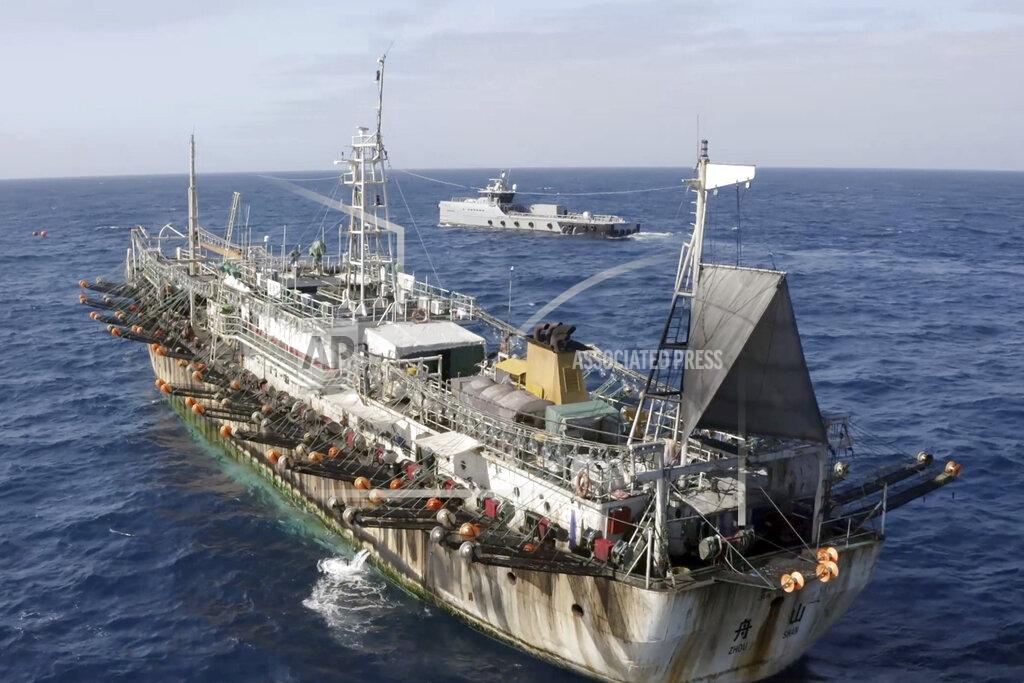 Isaac Haslam In this July 2021 photo provided by Sea Shepherd, the Ocean Warrior, background, circles a Chinese-flagged vessel on the high seas off the west coast of South America. (Isaac Haslam/Sea Shepherd via AP)