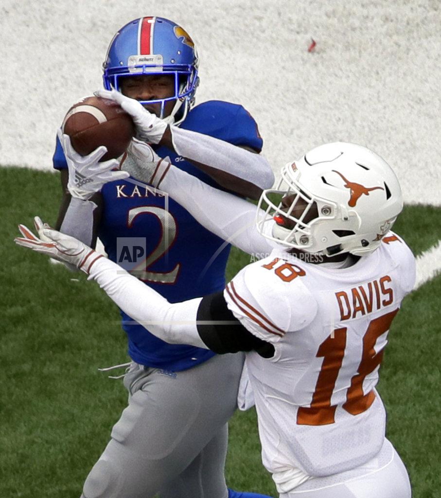 Orlin Wagner Kansas wide receiver Daylon Charlot (2) catches a touchdown pass while covered by Texas defensive back Davante Davis (18) during the second half of an NCAA college football game in Lawrence, Kan., Friday, Nov. 23, 2018. Texas defeated Kansas 24-17. (AP Photo/Orlin Wagner)