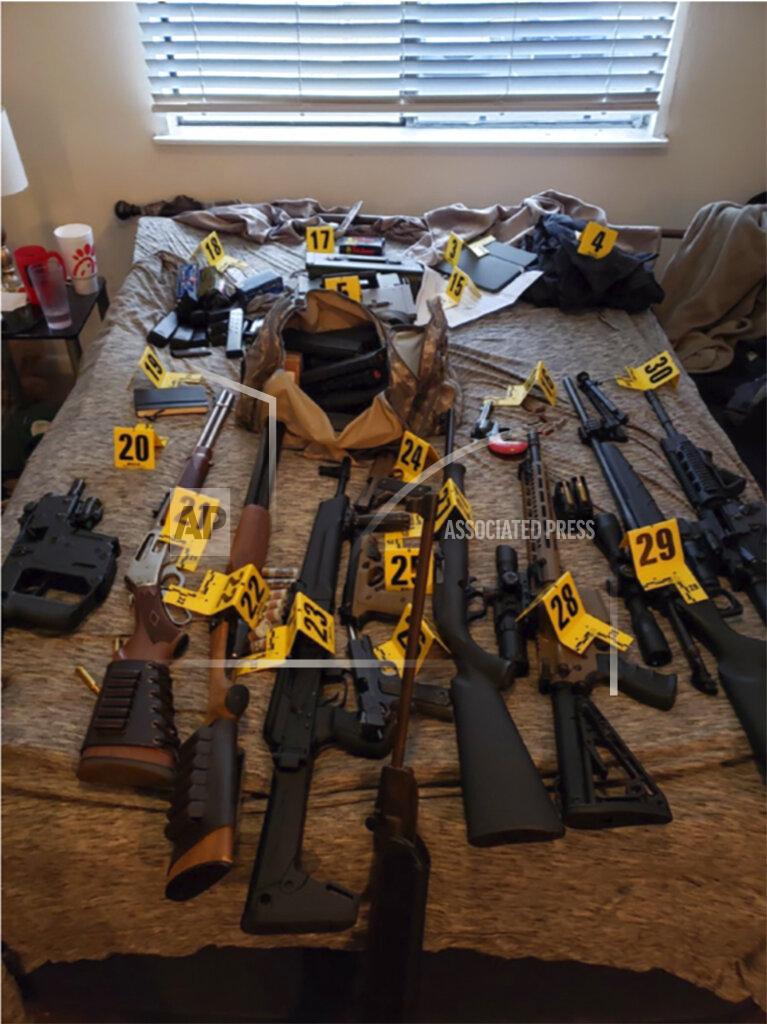 Uncredited This photo provided by U.S. Attorney for the Middle District of Tennessee shows an evidence photo showing assault rifles that were found during a search of Eric Munchel's home. In a court filing ahead of a Friday, Jan. 22, 2021 detention hearing, prosecutors describe a search of Munchel's home that turned up assault rifles, a sniper rifle with a tripod, shotguns, pistols, hundreds of rounds of ammunition, and a drum-style magazine. Prosecutors also said they have reason to believe Munchel may have had weapons with him in Washington D.C. that he stashed outside the Capitol before entering. (U.S. Attorney for the Middle District of Tennessee via AP)