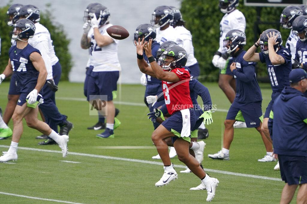 Ted S. Warren Seattle Seahawks quarterback Russell Wilson (3) catches a football as he runs a drill during NFL football practice Tuesday, June 15, 2021, in Renton, Wash. (AP Photo/Ted S. Warren)