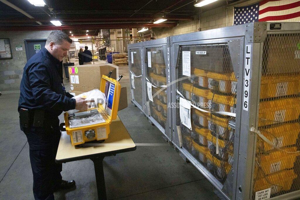 FILE — In this March 24, 2020 file photo, Vincent Dellova, a coordinator at the New York City Emergency Management Warehouse, packs up a ventilator, part of a shipment of 400, in New York. New York and New Jersey, early hot spots during the COVID-19 pandemic, have so far declined to release detailed breakdowns of their spending on personal protective gear and medical equipment during the first frenzied months of the virus outbreak. (AP Photo/Mark Lennihan, File)