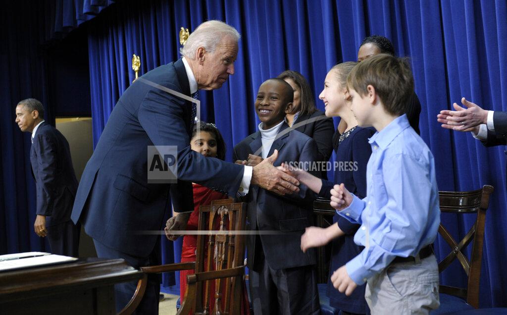 Susan Walsh FILE - Vice President Joe Biden shakes hands with Julia Stokes, 11, following a news conference on proposals to reduce gun violence, Jan. 16, 2013, in the South Court Auditorium at the White House in Washington. Obama and Biden were joined by law enforcement officials, lawmakers and children who wrote the president about gun violence following the shooting at an elementary school in Newtown, Conn., last month. Other letter writers included are, Hinna Zeejah, center in red, Taejah Goode and Grant Fritz, right. (AP Photo/Susan Walsh, File)
