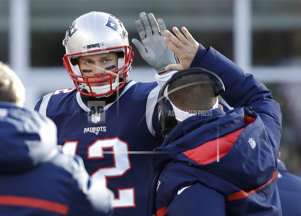 Elise Amendola New England Patriots offensive coordinator Josh McDaniels, right, gives a high-five to quarterback Tom Brady during the first half of an NFL divisional playoff football game against the Los Angeles Chargers, Sunday, Jan. 13, 2019, in Foxborough, Mass. (AP Photo/Elise Amendola)