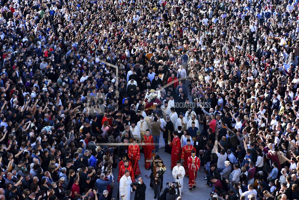 Risto Bozovic Believers carry coffin of Bishop Amfilohije, the head of the Serbian Orthodox Church in Montenegro, in Podgorica, Montenegro, Saturday, Oct. 31, 2020. The church said the 82-year-old died Friday from pneumonia caused by COVID-19. Amfilohije, known for his staunch anti-Western and pro-Russian political views, played a key role in leading the anti-government protests and putting together an opposition coalition that is currently trying to form the country's new government. (AP Photo/Risto Bozovic)