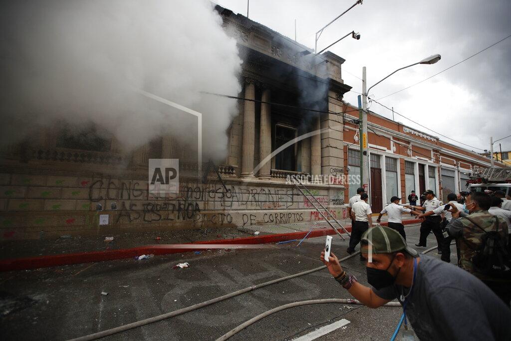 Moises Castillo Clouds of smoke shoot out from the Congress building after protesters set a part of it on fire, in Guatemala City, Saturday, Nov. 21, 2020. Hundreds of protesters were protesting in various parts of the country Saturday against Guatemalan President Alejandro Giammattei and members of Congress for the approval of the 2021 budget that reduced funds for education, health and the fight for human rights. (AP Photo/Moises Castillo)