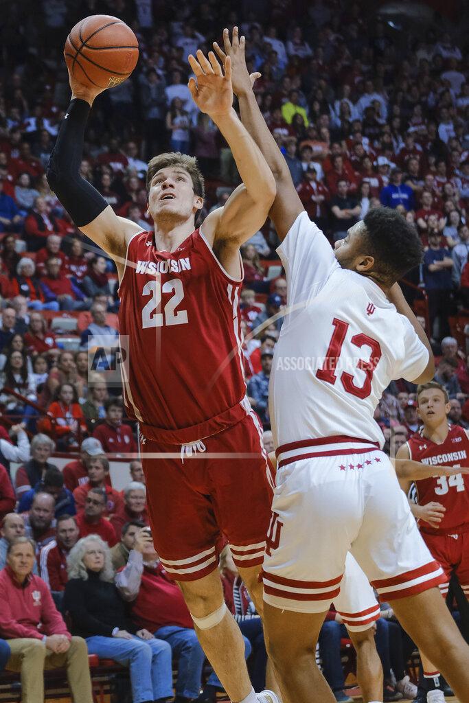 Aj Mast Wisconsin forward Ethan Happ (22) shoots next to Indiana forward Juwan Morgan (13) during the first half of an NCAA college basketball game in Bloomington, Ind., Tuesday, Feb. 26, 2019. (AP Photo/AJ Mast)