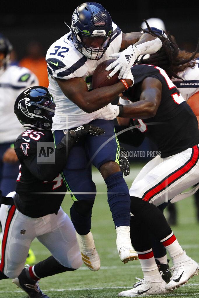 John Bazemore Seattle Seahawks running back Chris Carson (32) runs into Atlanta Falcons linebacker Deion Jones (45) and Atlanta Falcons linebacker Jermaine Grace (53) during the first half of an NFL football game, Sunday, Oct. 27, 2019, in Atlanta. (AP Photo/John Bazemore)