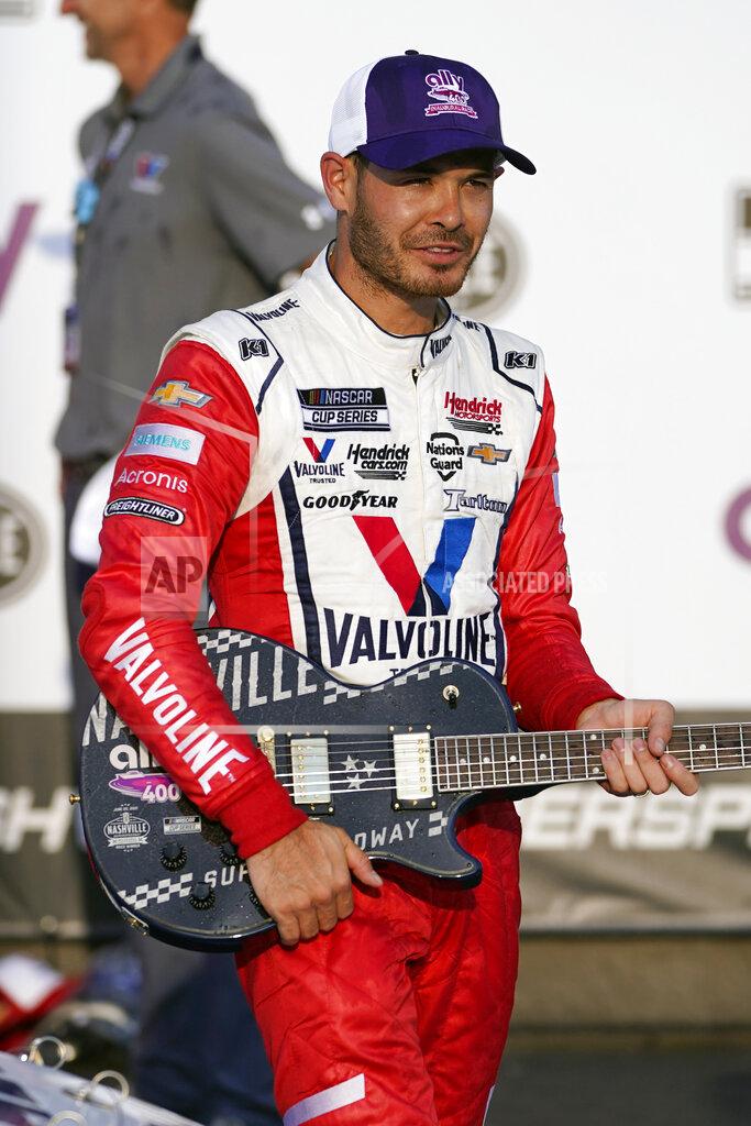 Mark Humphrey Kyle Larson holds the winner's guitar after winning a NASCAR Cup Series auto race at Nashville Superspeedway Sunday, June 20, 2021, in Lebanon, Tenn. (AP Photo/Mark Humphrey)