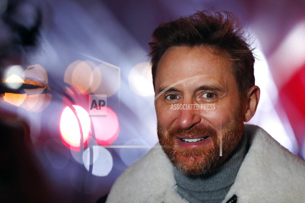 Thibault Camus French DJ David Guetta answers reporters in the courtyard of the Louvre museum, in Paris, Tuesday, Dec. 29, 2020 before recording his show. Superstar DJ David Guetta has, quite literally, been brought back to Earth by the coronavirus pandemic and says his music has benefitted as a result. Back in his native Paris to record a New Year's Eve show, the composer of ear-worm dance hits said he has produced "tons of new music" while hunkering down from the virus.(AP Photo/Thibault Camus)