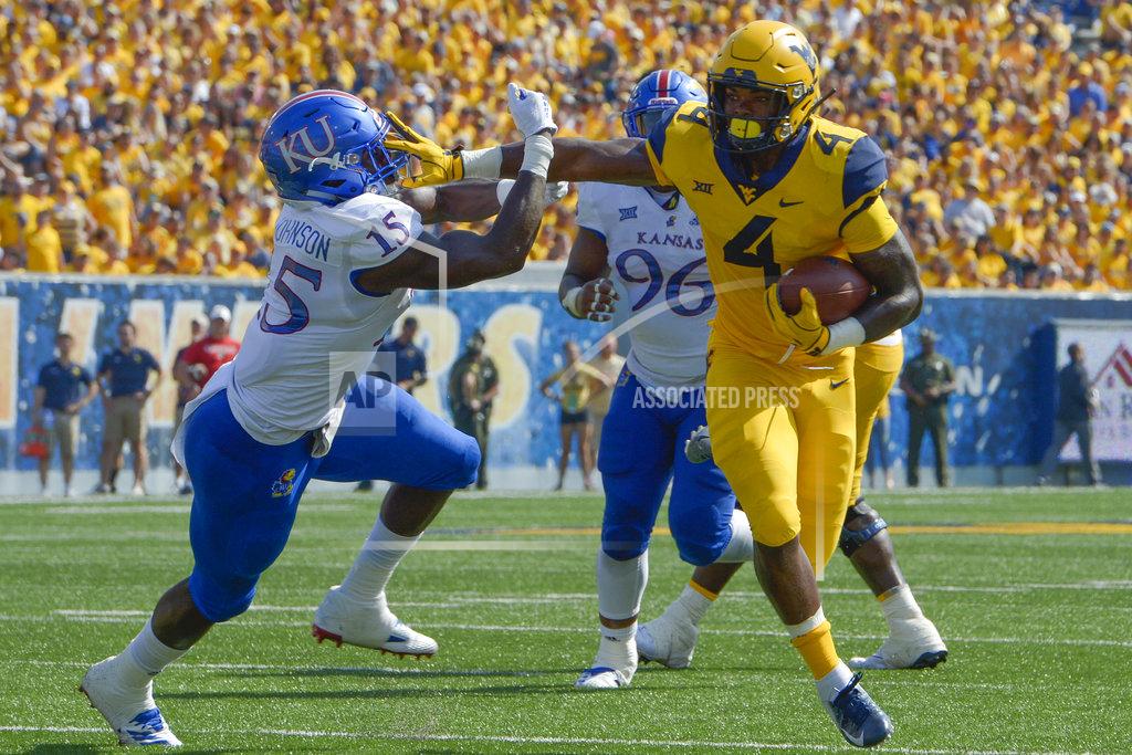 Craig Hudson West Virginia running back Leddie Brown (4) outmaneuvers Kansas linebacker Kyron Johnson (15) during the first half of an NCAA college football game against Kansas in Morgantown, W. Va., Saturday Oct. 6, 2018. (AP Photo/Craig Hudson)