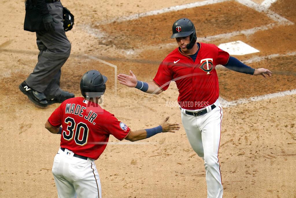 Jim Mone Minnesota Twins' LaMonte Wade, Jr., left, greets Brent Rooker after they both scored on a bases loaded double by Eddie Rosario off Detroit Tigers pitcher Daniel Norris in the third inning of a baseball game Monday, Sept. 7, 2020, in Minneapolis. (AP Photo/Jim Mone)