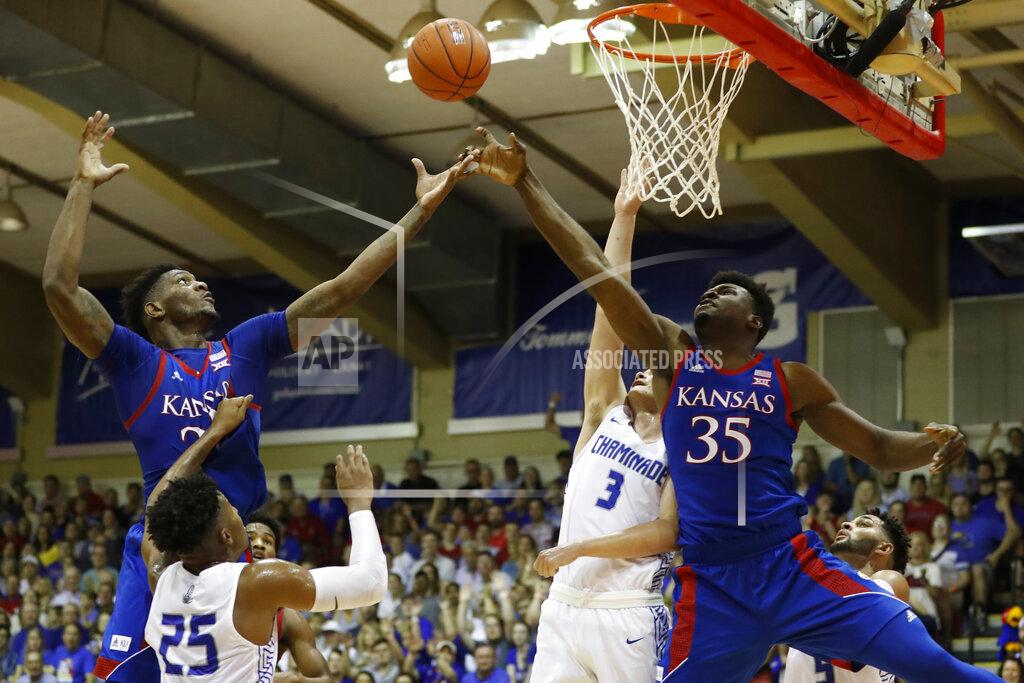 Marco Garcia Kansas forward Silvio De Sousa (22) and center Udoka Azubuike (35) for for a rebound over Chaminade guard Kendall Small (25) and forward Eliet Donley (3) during an NCAA college basketball game Monday, Nov. 25, 2019, in Lahaina, Hawaii. (AP Photo/Marco Garcia)