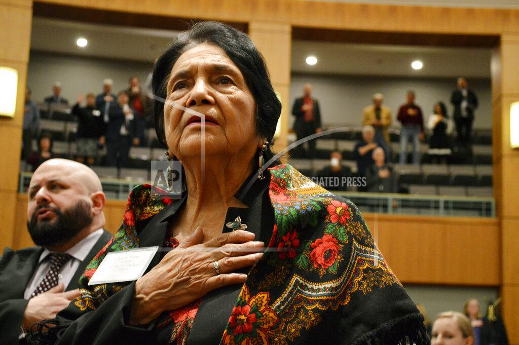Russell Contreras FILE - In this Feb. 27, 2019, file photo, Dolores Huerta, the Mexican-American social activist who formed a farmworkers union with Cesar Chavez, stands for the Pledge of Allegiance in Spanish while visiting the New Mexico Statehouse in Santa Fe, N.M. Immigrant rights activists energized by a new Democratic administration and majorities on Capitol Hill are gearing up for a fresh political battle to push through a proposed bill from President Joe Biden that would open a pathway to citizenship for up to 11 million people. Huerta said the immigration reform push will benefit from the dramatic stories of children being separated from their parents under the Trump administration. (AP Photo/Russell Contreras, File)