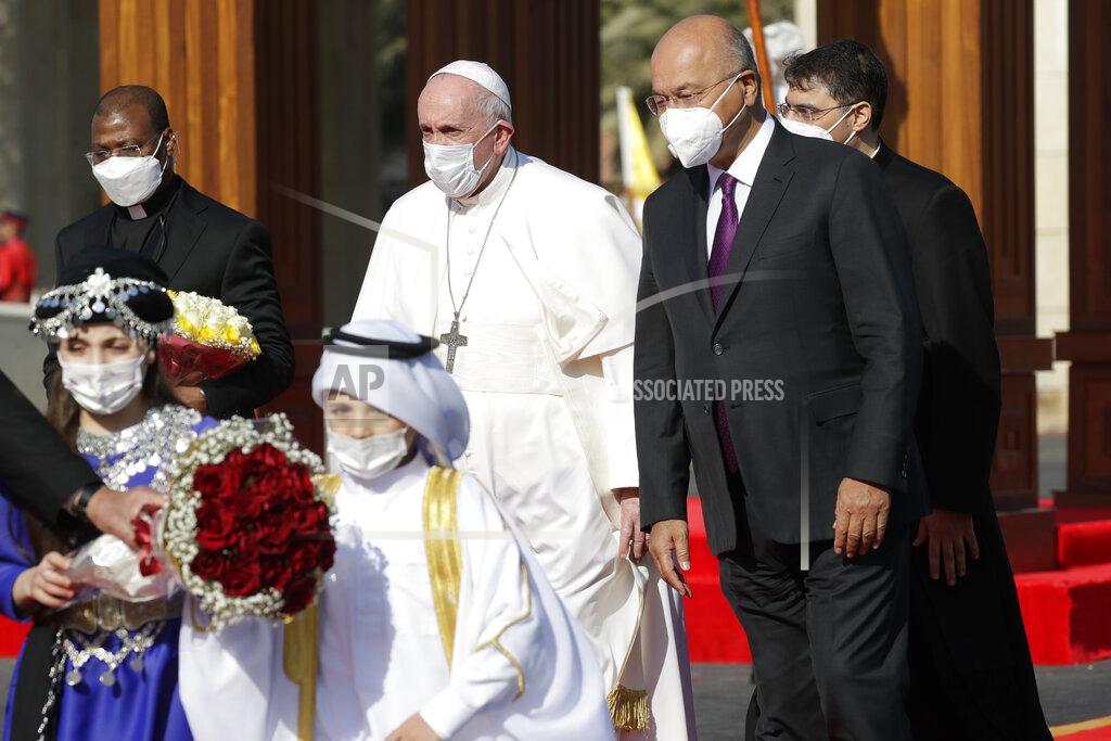 Andrew Medichini Pope Francis is welcomed by Iraqi President Barham Salih, at Baghdad's Presidential Palace, Iraq, Friday, March 5, 2021. Pope Francis has arrived in Iraq to urge the country's dwindling number of Christians to stay put and help rebuild the country after years of war and persecution, brushing aside the coronavirus pandemic and security concerns. (AP Photo/Andrew Medichini)