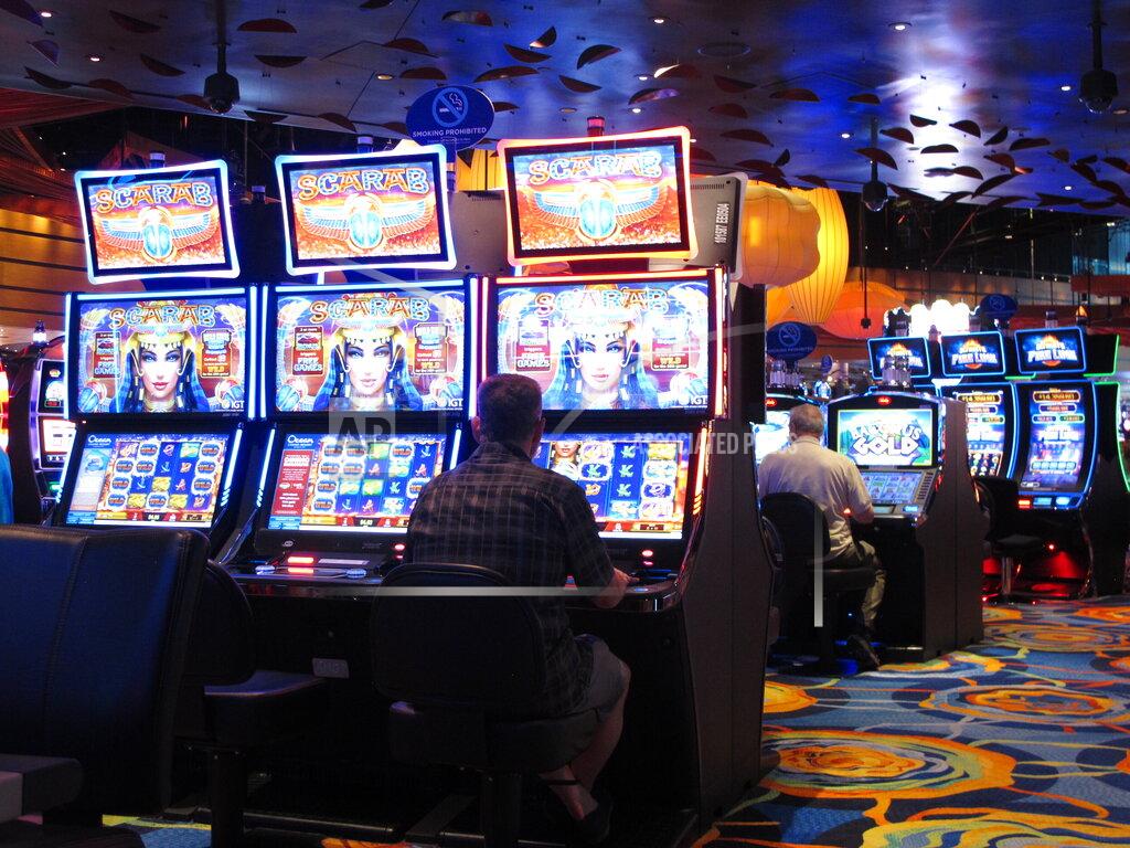 Wayne Parry FILE - This June 18, 2019, file photo shows gamblers playing slot machines at the Ocean Casino Resort in Atlantic City, N.J. On April 6, 2021, Luxor Capital, the New York hedge fund that owns the casino, told The Associated Press it is selling an ownership interest of up to 50% in the casino to the Ilitch family of Detroit, which owns professional sports teams, the Little Caesars pizza chain, and a Detroit casino. (AP Photo/Wayne Parry, File)