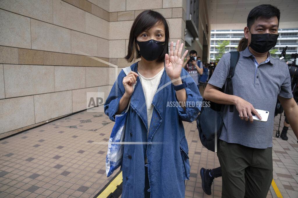 Kin Cheung FILE - In this June 19. 2021, file photo, Chan Pui-man, left, associate publisher of Apple Daily newspaper, and Lam Man-chung, right, executive editor-in-chief walk out from court in Hong Kong. Hong Kong police charged two top editors and two editorial writers at Apple Daily with collusion weeks after the city's largest pro-democracy newspaper was forced to cease publication and its assets were frozen. All four were charged with conspiring to "collude with a foreign country or with external elements to endanger national security" under the city's year-old national security law and appeared in court Thursday, July 22, 2021. (AP Photo/Kin Cheung)