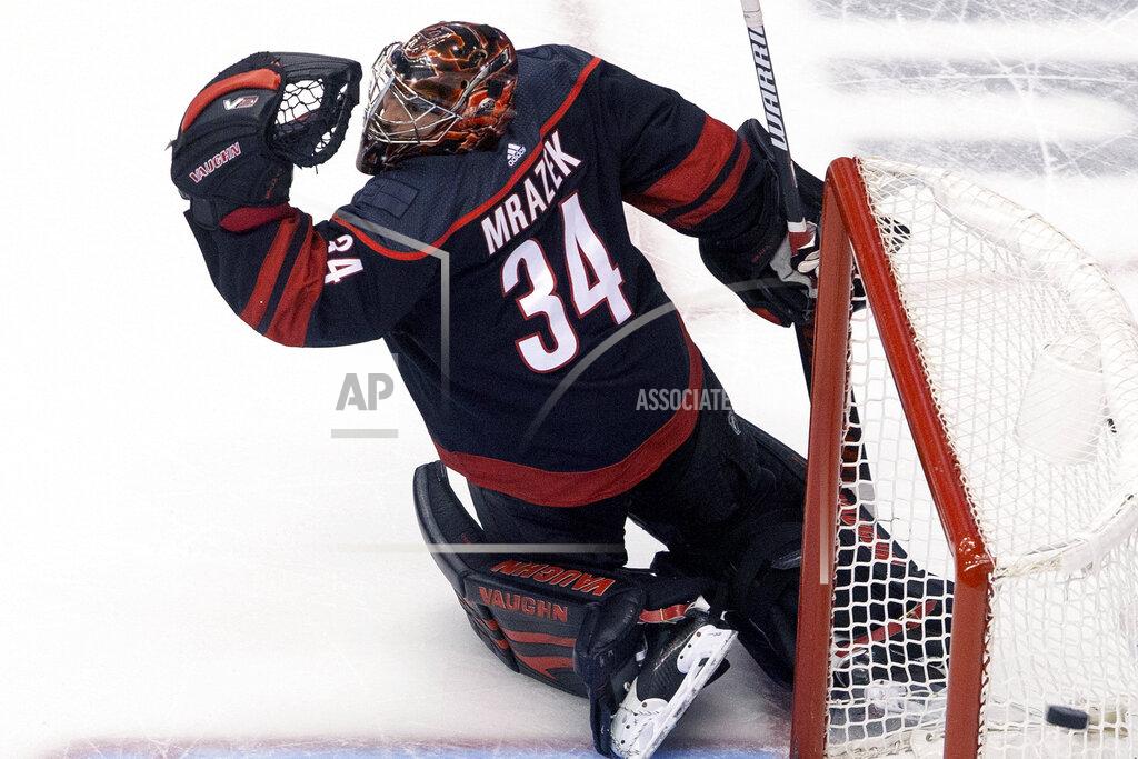 Chris Young Carolina Hurricanes goaltender Petr Mrazek (34) watches as the puck goes wide of the goal during third period NHL Eastern Conference Stanley Cup playoff game in Toronto on Saturday, Aug. 15, 2020. (Chris Young/The Canadian Press via AP)
