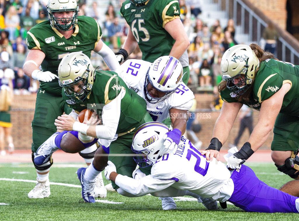 Mike Caudill William & Mary quarterback Kilton Anderson, left, is brought down by James Madison's Diamonte Tucker-Dorsey (20) and Semaj Sorhaindo (92) during the first half of an NCAA college football game in Williamsburg, Va., on Saturday, Oct. 19, 2019. (Mike Caudill/The Virginian-Pilot via AP)