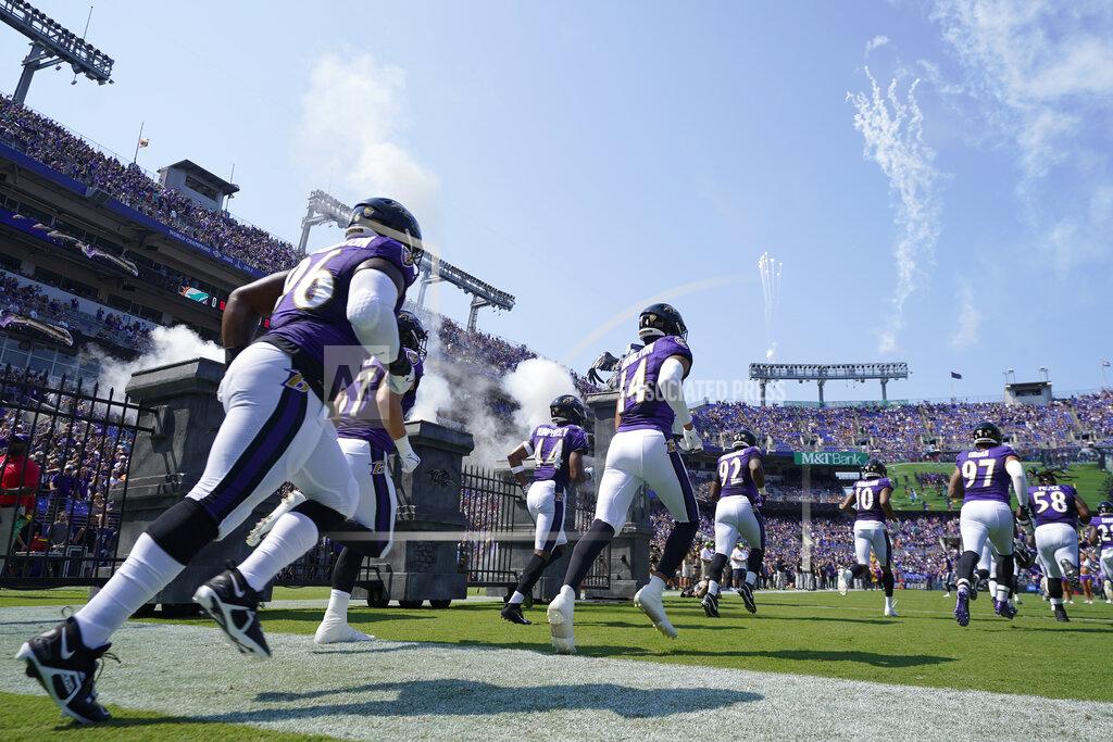The Baltimore Ravens team enters the field during before an NFL football game against the Miami Dolphins, Sunday, Sept. 18, 2022, in Baltimore. (AP Photo/Julio Cortez)