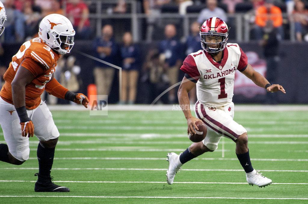 Jeffrey Mcwhorter Oklahoma quarterback Kyler Murray (1) scrambles away from Texas defensive lineman Malcolm Roach (32) during the first half of the Big 12 Conference championship NCAA college football game on Saturday, Dec. 1, 2018, in Arlington, Texas. (AP Photo/Jeffrey McWhorter)