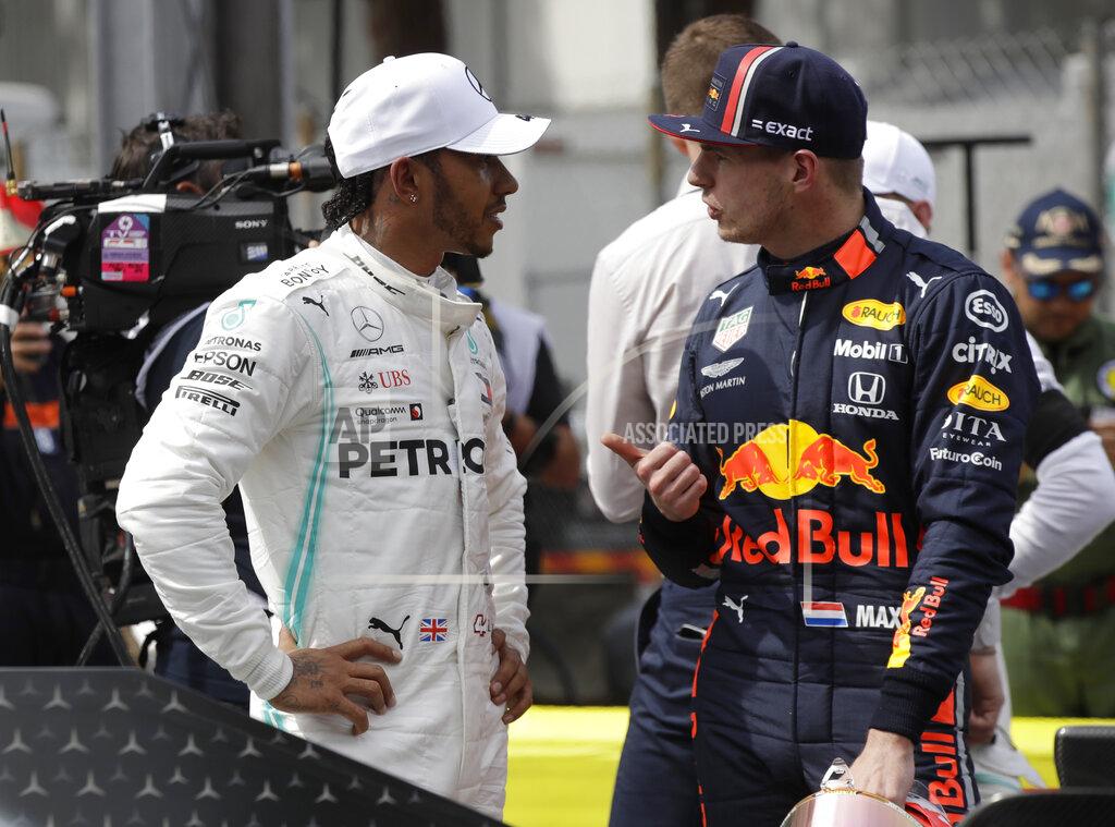 Luca Bruno Mercedes driver Lewis Hamilton of Britain, left, who earned pole position, speaks with Red Bull driver Max Verstappen of the Netherland's, who came in the third place, after the qualifying session at the Monaco racetrack, in Monaco, Saturday, May 25, 2019. The Formula one race will be held on Sunday. (AP Photo/Luca Bruno)