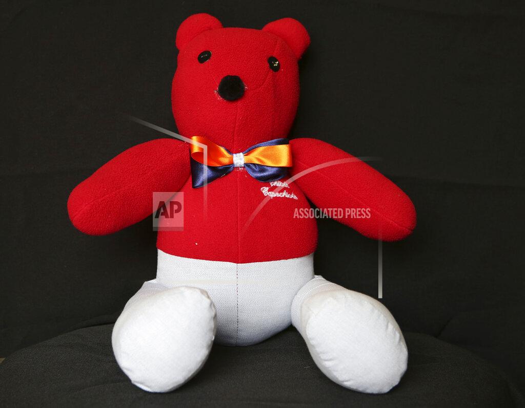 A teddy bear made with clothes that were worn by Gonzalo Mata who died from COVID-19, sits in the workshop of seamstress Irma de la Parra, in Mexico City, Saturday, April 24, 2021. De la Parra used to make teachers' gowns, but school closings during the pandemic left her without a job. She took it upon herself to make teddy bears out of clothing from those who died of COVID-19 to give those who are still alive a chance to grieve and be closer to those they were unable to bid farewell to. (AP Photo/Ginnette Riquelme)