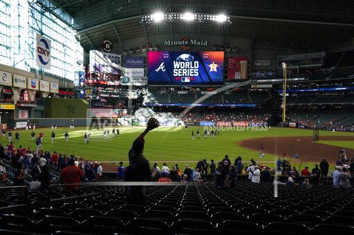 A fan waits for a fly ball during batting practice before Game 2 of baseball's World Series between the Houston Astros and the Atlanta Braves Wednesday, Oct. 27, 2021, in Houston. (AP Photo/Ashley Landis)