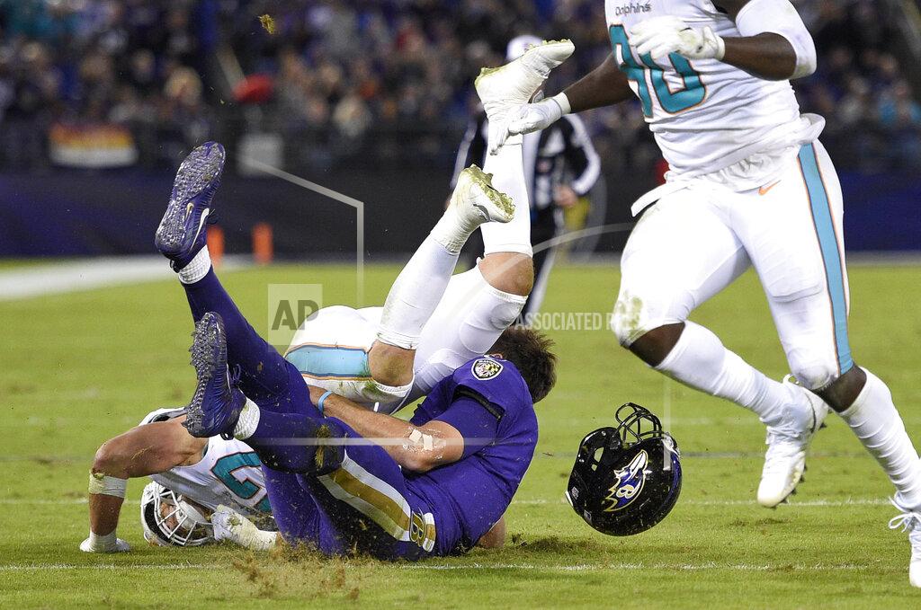 Nick Wass FILE - In this Oct. 26, 2017, file photo, Miami Dolphins middle linebacker Kiko Alonso, top left, collides with Baltimore Ravens quarterback Joe Flacco as Flacco slides on the field after rushing the ball in the first half of an NFL football game in Baltimore. Flacco was the Super Bowl MVP and the NFL's highest-paid quarterback just a few years ago. After injuries shortened his last two seasons, Flacco is now in New York with a new role: as a backup to Sam Darnold. (AP Photo/Nick Wass, File)