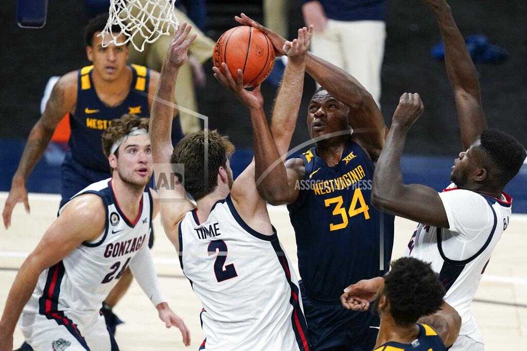 Darron Cummings West Virginia's Oscar Tshiebwe (34) is fouled by Gonzaga's Drew Timme (2) during the first half of an NCAA college basketball game Wednesday, Dec. 2, 2020, in Indianapolis. (AP Photo/Darron Cummings)