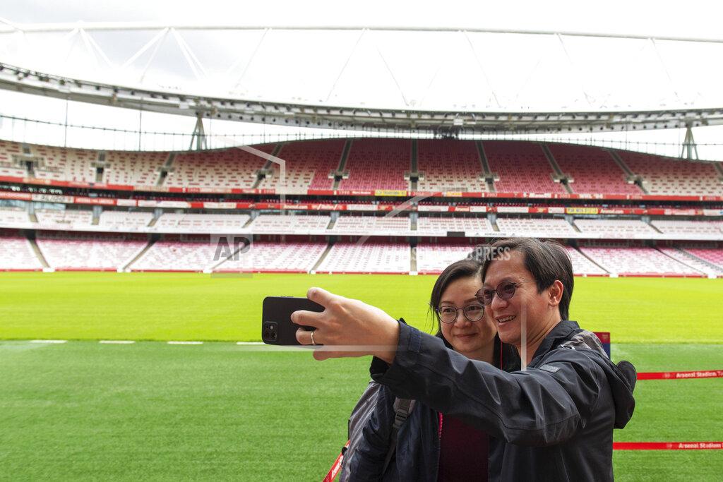 Dominic Lipinski People enjoy a free stadium tour after receiving their covid vaccines at a mass coronavirus vaccination centre held in Arsenal's Emirates Stadium, in north London, Friday June 25, 2021. (Dominic Lipinski/PA via AP)