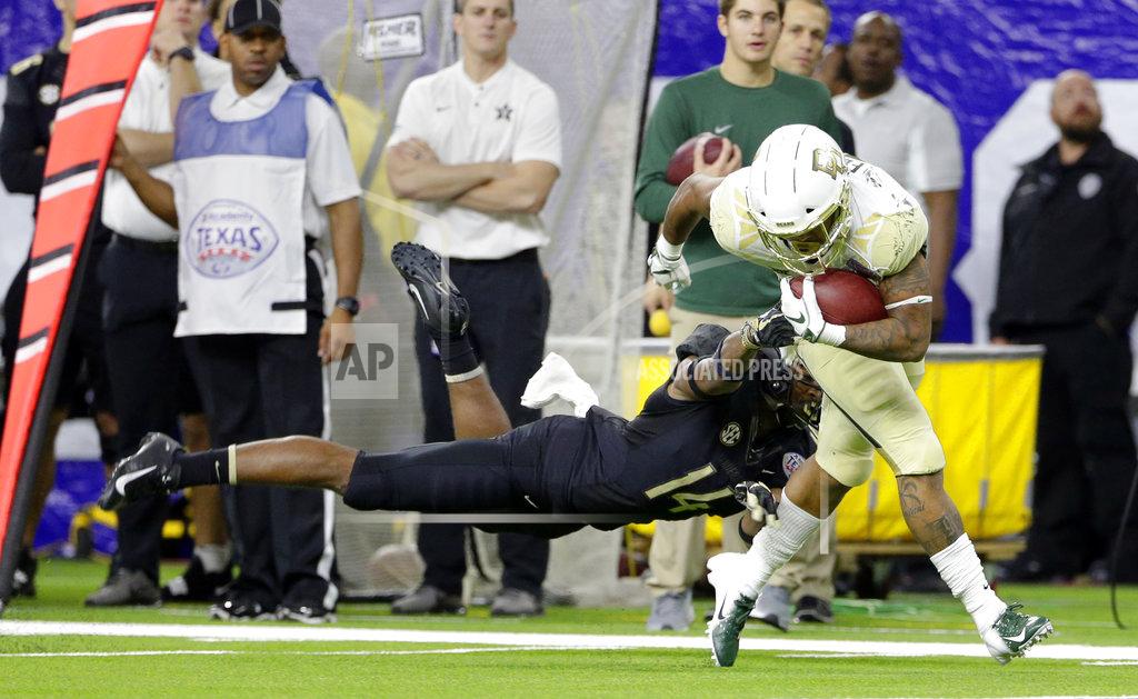 Michael Wyke Vanderbilt defensive back Max Worship (14) makes an unsuccessful diving tackle attempt on Baylor running back Trestan Ebner (25) on his touchdown run during the second half of the Texas Bowl NCAA college football game, Thursday, Dec. 27, 2018, in Houston. (AP Photo/Michael Wyke)