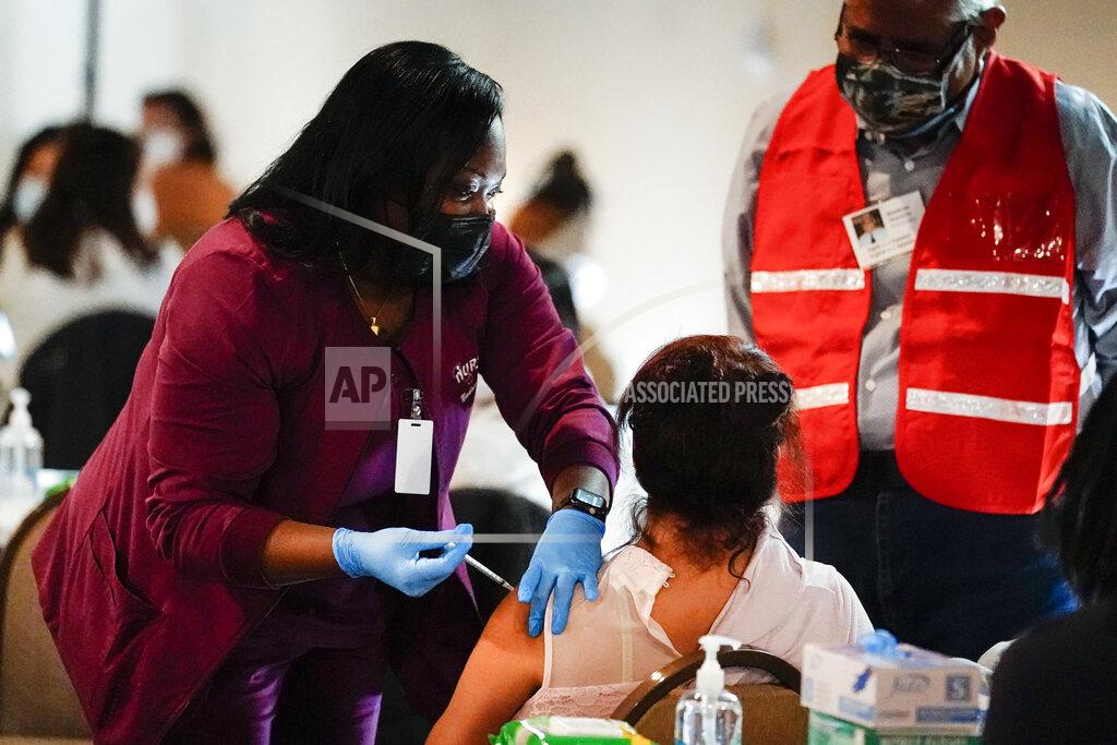 Matt Rourke FILE - In this March 17, 2021, file photo, health worker administers a dose of a Pfizer COVID-19 vaccine during a vaccination clinic at the Grand Yesha Ballroom in Philadelphia. More than three months into the U.S. vaccination drive, many of the numbers paint an increasingly encouraging picture as dozens of states have thrown open vaccinations to all adults or are planning to do so in a matter of weeks. (AP Photo/Matt Rourke, File)
