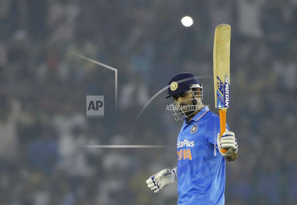 Tsering Topgyal FILE - In thos Sunday, Oct. 23, 2016, file photo, Indian cricket captain Mahendra Singh Dhoni raises his bat after scoring half a century during the third one-day international cricket match against New Zealand in Mohali, India. India great Dhoni announced his retirement from international cricket on Saturday, Aug. 15, 2020. Under Dhoni’s stewardship, India won the T20 World Cup in 2007, the 50-over World Cup in 2011 and the Champions Trophy in 2013. (AP Photo/Tsering Topgyal, File)