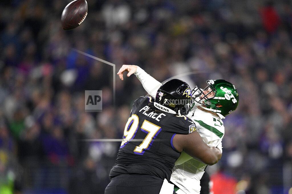 Nick Wass New York Jets quarterback Sam Darnold, right, tries to make a pass while taking a hit from Baltimore Ravens defensive tackle Michael Pierce (97) during the first half of an NFL football game, Thursday, Dec. 12, 2019, in Baltimore. (AP Photo/Nick Wass)