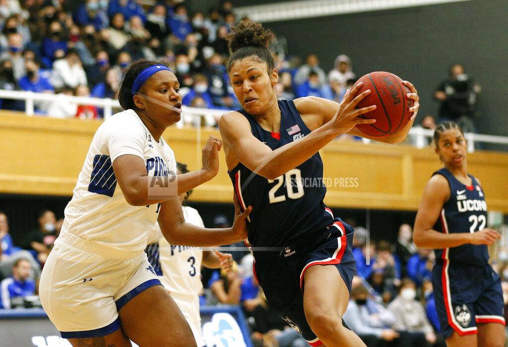 Noah K. Murray Connecticut forward Olivia Nelson-Ododa (20) drives to the basket against Seton Hall forward Sidney Cooks during the second half of an NCAA college basketball game on Friday, Dec. 3, 2021, in South Orange, N.J. (AP Photo/Noah K. Murray)