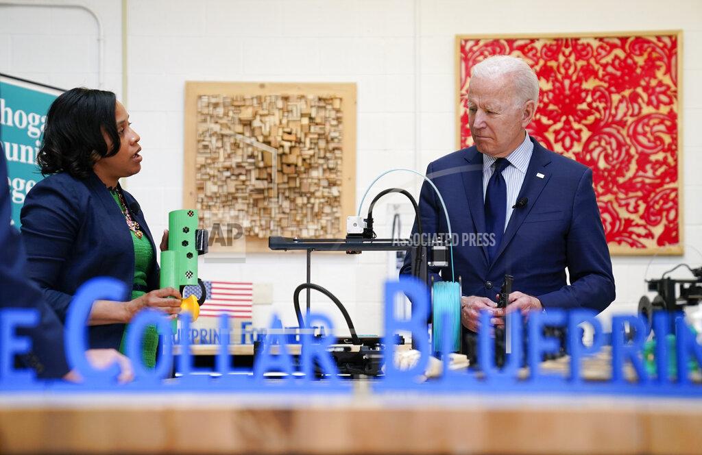 Evan Vucci President Joe Biden listens during a tour of the Cuyahoga Community College Manufacturing Technology Center, Thursday, May 27, 2021, in Cleveland. (AP Photo/Evan Vucci)