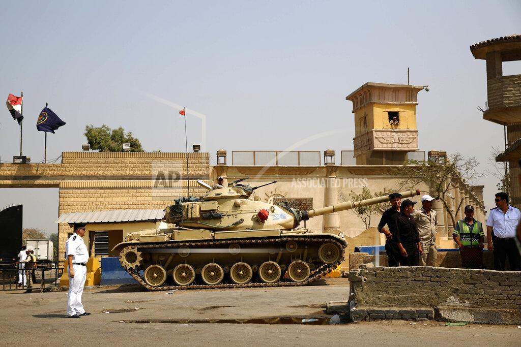 Hassan Ammar FILE - In this Aug. 2, 2015 file photo, Egyptian security forces stand guard outside one of the entrances of Tora prison, in Cairo, Egypt. Since the coronavirus first hit Egypt in February 2020, At least 10 doctors and six journalists have been arrested according to rights groups. Other health workers say they have been warned by administrators to keep quiet or face punishment. One foreign correspondent has fled the country, fearing arrest, and another two have been summoned for reprimand over their reporting of “disinformation" and other “violations.” (AP Photo/Hassan Ammar, File)