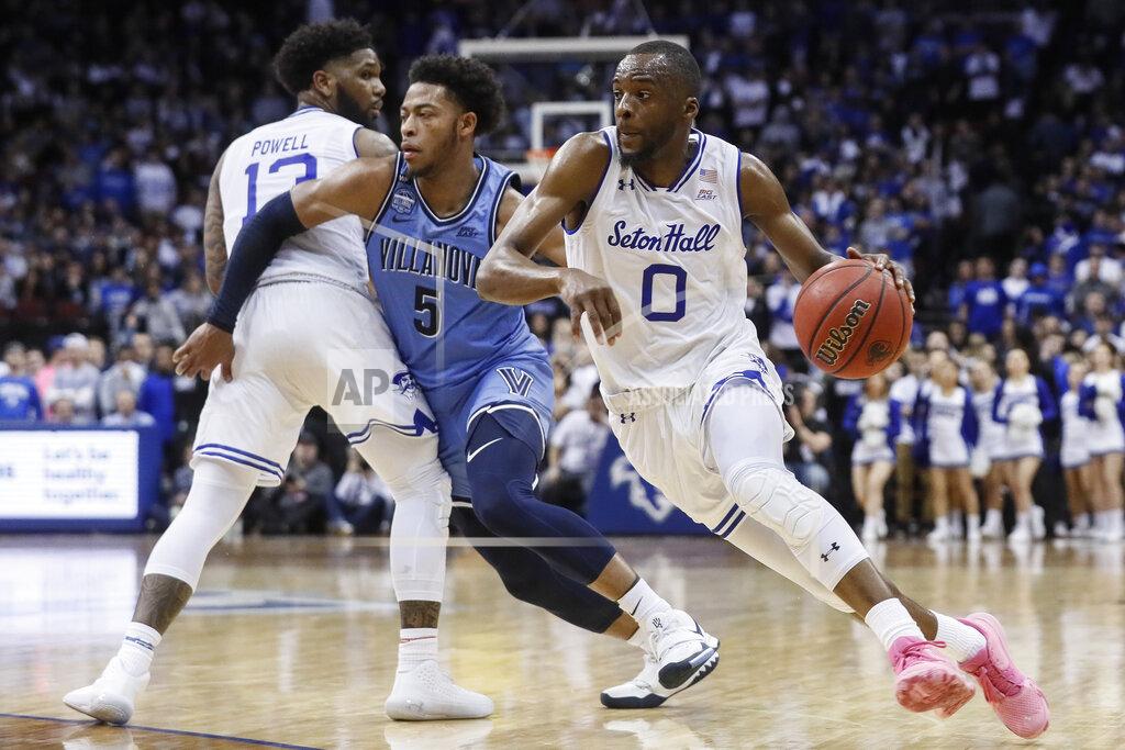 John Minchillo Seton Hall's Quincy McKnight (0) drives around Villanova's Justin Moore (5) during the second half of an NCAA college basketball game Wednesday, March 4, 2020, in Newark, N.J. (AP Photo/John Minchillo)