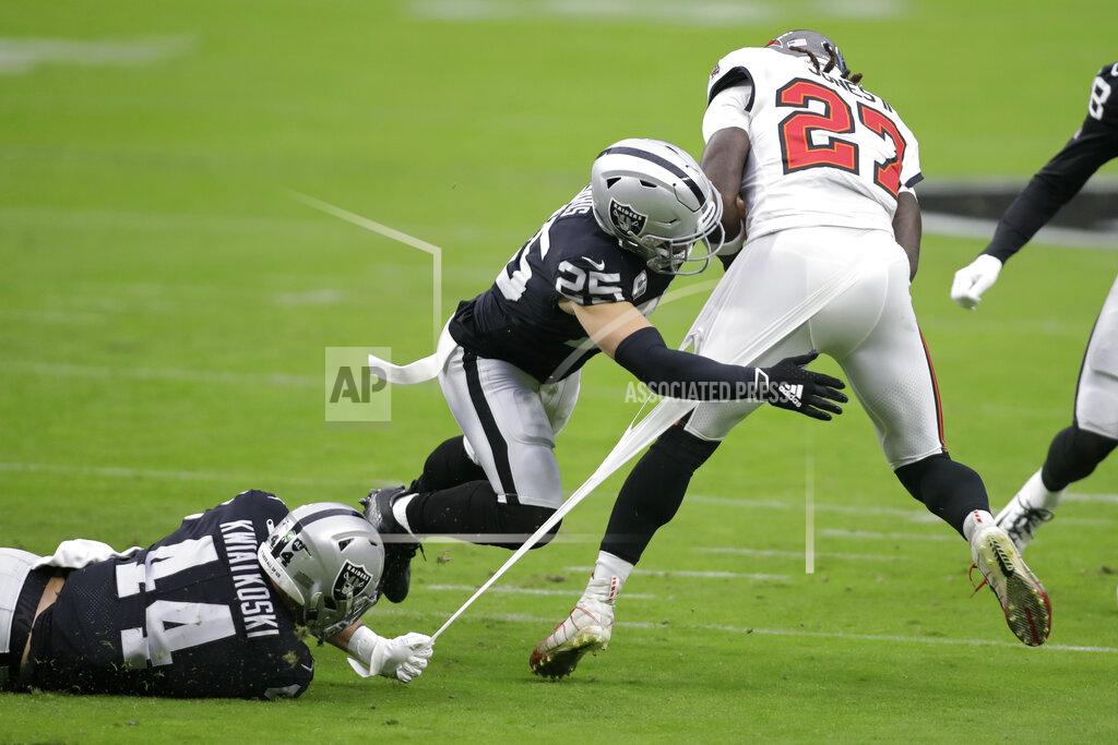 Isaac Brekken Las Vegas Raiders inside linebacker Nick Kwiatkoski (44) and free safety Erik Harris (25) attempt to tackle Tampa Bay Buccaneers running back Ronald Jones (27) during the first half of an NFL football game, Sunday, Oct. 25, 2020, in Las Vegas. (AP Photo/Isaac Brekken)