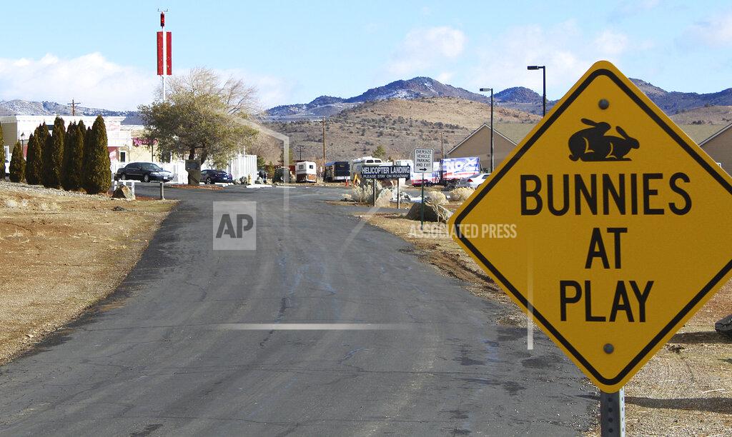 Ryan Tarinelli FILE - In this Feb. 27, 2019, file photo, the Moonlite Bunny Ranch brothel is seen in Lyon County east of Carson City, Nev. For nearly a year, Nevada's legal brothels have been shuttered due to the coronavirus, leaving sex workers trying to pay their bills turning to alternatives like offering "virtual dates" online or non-sexual escort services. (AP Photo/Ryan Tarinelli, File)