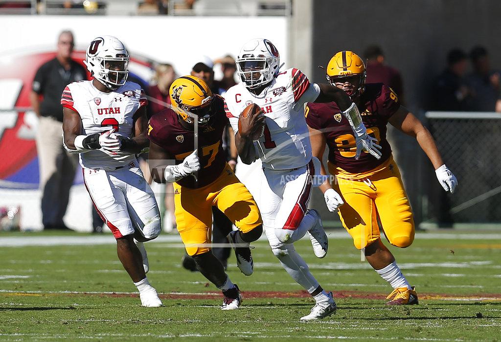 Rick Scuteri Utah quarterback Tyler Huntley (1) runs away from Arizona State defenders in the first half during an NCAA college football game, Saturday, Nov. 3, 2018, in Tempe, Ariz. (AP Photo/Rick Scuteri)