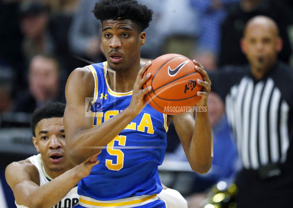 David Zalubowski FILE - In this Saturday, Feb. 22, 2020, file photo, UCLA guard Chris Smith drives past Colorado guard Tyler Bey, obscured at left, in the first half of an NCAA college basketball game in Boulder, Colo. The first-place Bruins own a half-game lead over Oregon and can clinch at least a share of the league crown with a victory at crosstown rival Southern California on Saturday, March 7, 2020. They haven't won the regular-season title since 2012-13. (AP Photo/David Zalubowski, File)