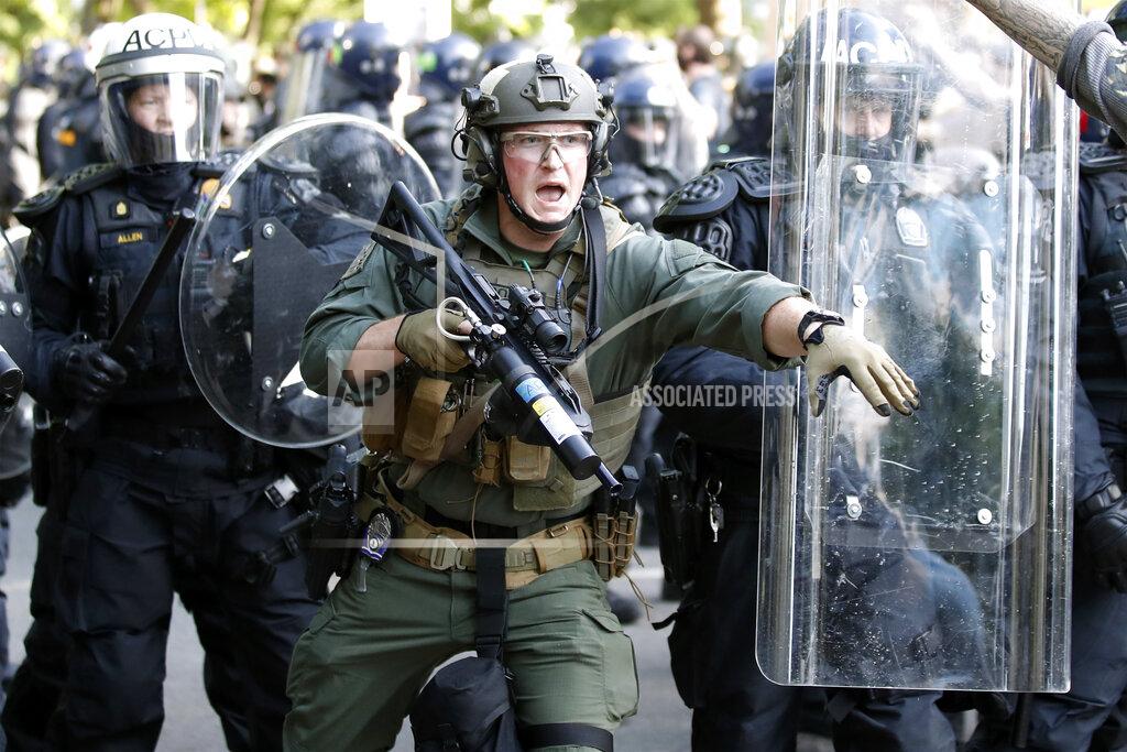 Police begin to clear demonstrators gathered as they protest the death of George Floyd, Monday, June 1, 2020, near the White House in Washington. Floyd died after being restrained by Minneapolis police officers. (AP Photo/Alex Brandon)