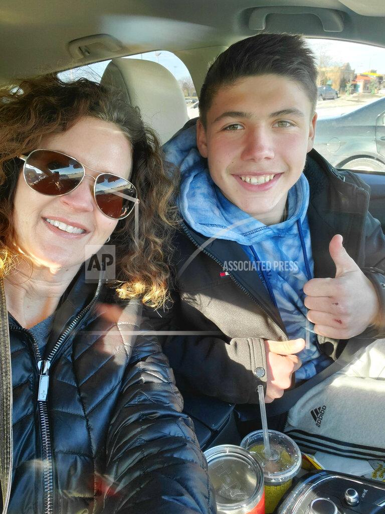 Uncredited Jessica Pflumm of Olathe, Kansas, poses with Maks, a Ukrainian boy she and her family are working to adopt. The Pflumms are among dozens of families whose adoptions are on hold because of the war in Ukraine. Russia’s invasion of Ukraine has halted the process of international adoption. Ukraine has stopped all international adoptions as the country copes with the turmoil unleashed on its courts by the war. (Photo Courtesy of Jessica Pflumm via AP)